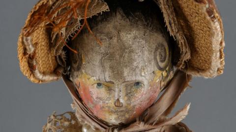 A painted face of a doll 