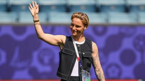 Jess Fishlock waves to fans