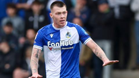Kacper Lopata gestures to his fellow defenders to calm down during a match for Bristol Rovers