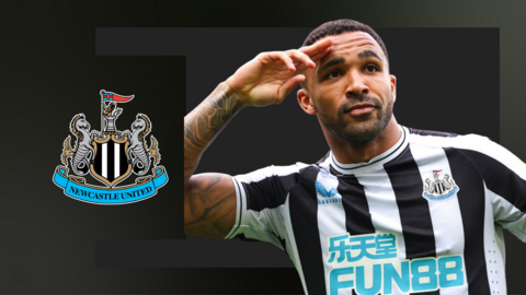 Callum Wilson salutes as a celebration in front of a Newcastle crest