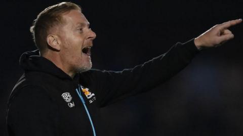 Cambridge United manager Garry Monk directs his team from the sidelines