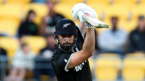New Zealand batter Daryl Mitchell watches the ball after playing a shot