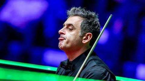 Ronnie O'Sullivan reacts during his second-round defeat at the World Grand Prix