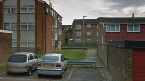 Two cars parked close to an alleyway by Waleys Close, Marsh Farm, Luton