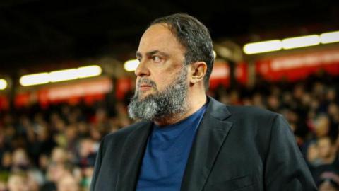 Evangelos Marinakis wearing a suit jacket