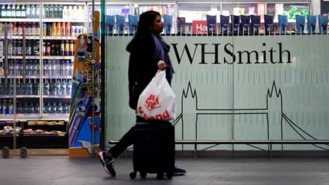 A pedestrian passes a WHSmith store in London, Britain, 25 January 2025. British retailer WHSmith said it is exploring options to sell its entire high street business. WHSmith has more than five hundred stores across the UK and employs some five thousand people.