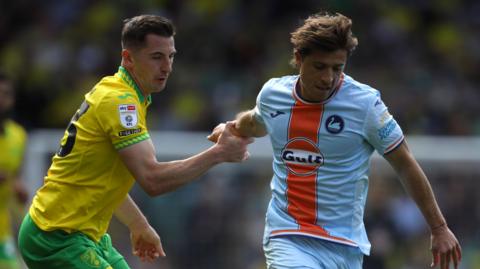  Kenny McLean of Norwich City and Goncalo Franco of Swansea City battle for the ball