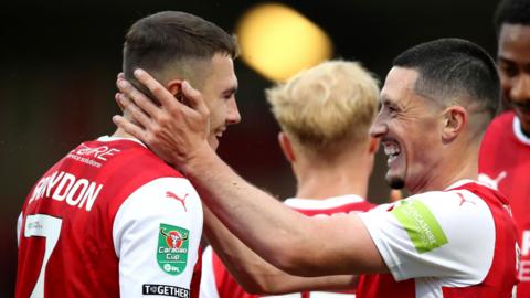Ronan Coughlan (right) puts his hands on the face of Fleetwood team-mate Ryan Graydon