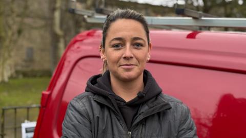 Gina York, stood by a red van, looking at the camera