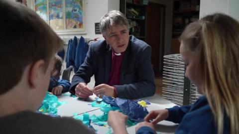 Bishop Hugh Nelson with two children 