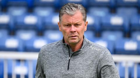 Steve Cotterill walking on the side of the pitch while manager of Forest Green Rovers.