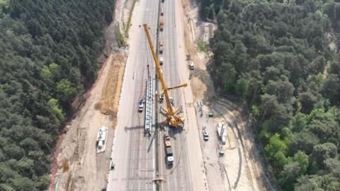 An aerial view of a crane on the M25