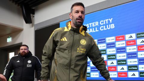 Ruud van Nistelrooy walking into his first news conference as Leicester manager