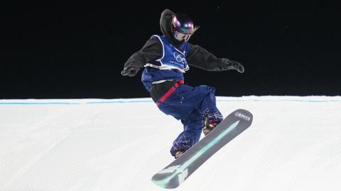 Mia Brookes snowboarding on Day 3 of the Winter Olympics in team GB bib over a black snowboarding outfit