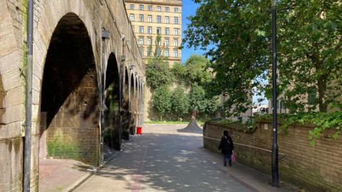 A commuter walks past one of the archways leading to Forster Square railway station