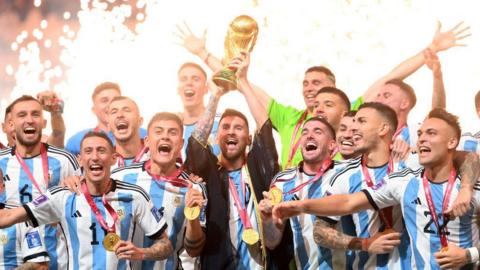 Messi lifting the World Cup trophy with his Argentina team mates in 2022.