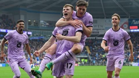 Rob Street of Lincoln City, second from left, celebrates scoring the opening goal with team-mates, from left, Reeco Hackett, Adam Reach and Ryley Towler 