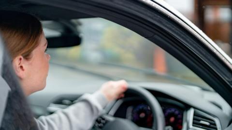 Driver behind the wheel of a car