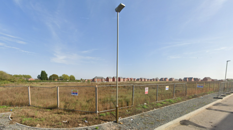 Fencing around a large grass area
