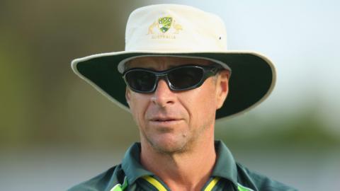 Troy Cooley looks on