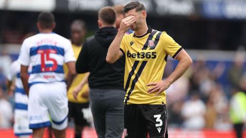Stoke City's Aaron Cresswell has his hands over his eyes at full-time following defeat to QPR