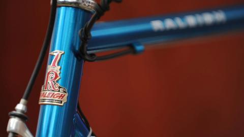 A close-up picture of a blue Raleigh bike