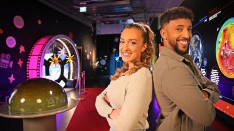 British Science Week 2026 Live Lesson presenters standing back to back, smiling.