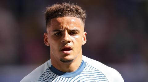 A head and shoulders picture of Bournemouth's Max Aarons wearing their changed blue and white strip 