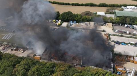 Smoke billowing from a fire at a waste services plant in Climping