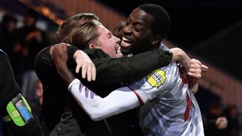 Ade Adeyemo hugs a Crawley fan after scoring against Mansfield