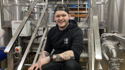 Man sitting on steps smiling at camera