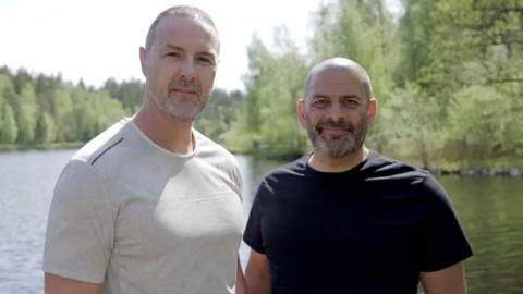Paddy McGuinness and Chris Harris in front of a tree-lined river