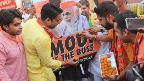 Bharatiya Janata Party (BJP) supporters celebrate after Indian prime minister claimed their party's victory in the election results at the BJP headquarters in New Delhi, India