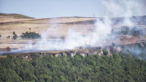 Smoke drifting across the moorland