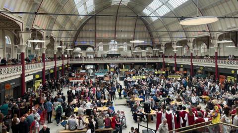 Large crowds inside a newly-refurbished Derby's Market Hall taken from the top terrace. 