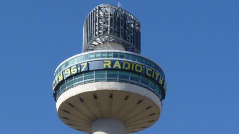 A close up of the tower. It has Radio City 96.7 wrapped around the top in yellow lettering.