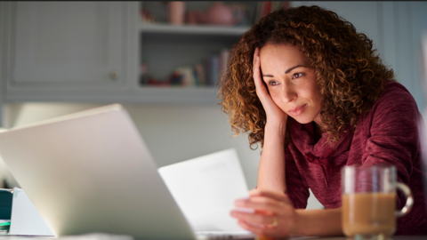 A woman looking frustrated by a computer