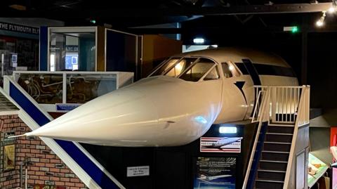 Mock up full-size replica of the front third of a Concorde aircraft - it has a cockpits and a mannequin pilot 