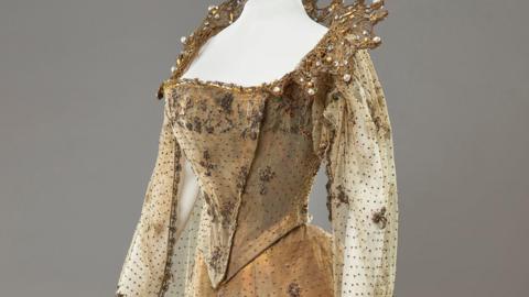 The bodice of a gold gown worn by Queen Alexandra.