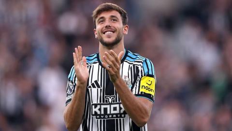 Nico Gonzalez applauds the Newcastle fans after being unveiled before their Carabao Cup against West Brom