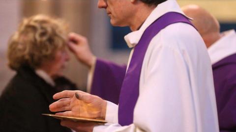Priests administer ashes on Ash Wednesday