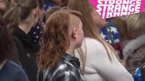 A boy with a mullet hair do