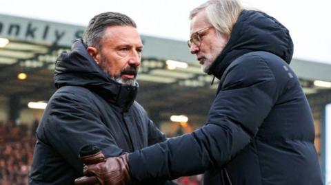 Heart of Midlothian head coach Derek McInnes and Dundee counterpart Steven Pressley shake hands
