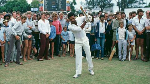 Bernard Julien warms up with a bat in his hands in front of a crowd in Durban, South Africa