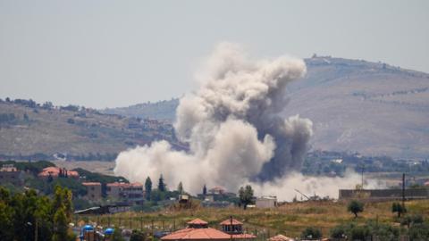 View from afar of large plumes of smoke rising over buildings struck by Israel in the Nabatieh area, southern Lebanon (4 January 2026)