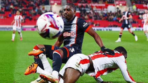 Amari'i Bell of Luton Town clashes with Stoke City's Junior Tchamadeu