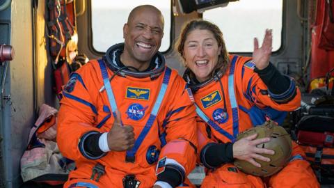Victor Glover and Christina Koch smiling after landing back on Earth.