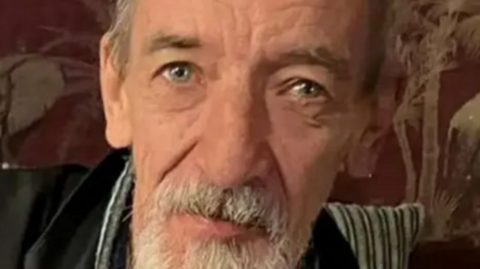 A man with a grey beard.