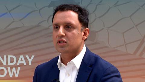 Scottish Labour leader, Anas Sarwar, wears a white shirt and dark blue blazer