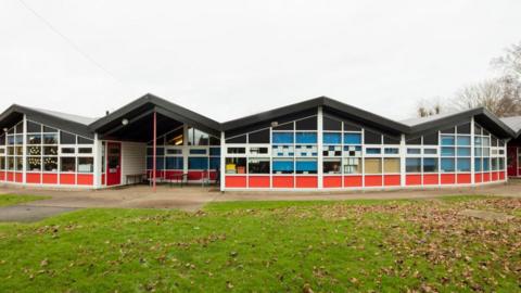 School building with lawn in foreground